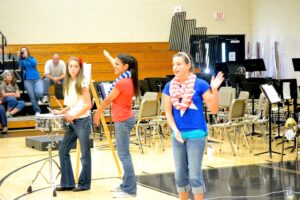 Students Cecilla Dukes, Destiny Manego, and Cloe Reynolds perform during the Veterans Day celebration at NHMS on Nov. 11, 2014.