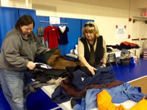 Family Connection Director Lee Kilby sorts through the clothes that were given to families.