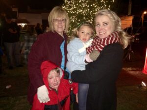 4-year old Maddox Meeks of Mt. Airy musters a smile amidst tears. He attended Saturday's Downtown Clarkesville Christmas celebration with his grandmother, Linda Skelton. Skelton's daughter Stacey Allen of Mt. Airy holds her 3-year old daughter Emma Grace.