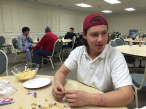 Garcia-Flores sits in the background. The church fellowship hall was the gathering place for socializing and activities on the cold winter nights.