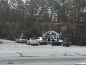 Tallulah Falls School President Larry Peevy speaks with law enforcement officers outside the gates to the main TFS campus on Hwy. 365.