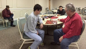 Garcia-Flores watches as shelter volunteers play checkers at First Baptist Church of Cornelia on Jan.9.