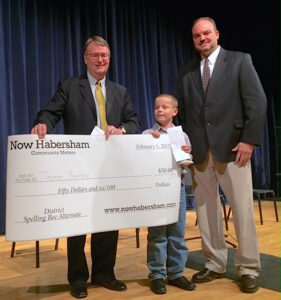 Demorest 4th grader Jayson Bentley placed second in the 2015 Habersham County Scripps Spelling Bee on Feb. 5. VFL board member Bill Loyd of Piedmont College (left) and Habersham County School Superintendent Matthew Cooper presented him with his prize check.