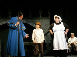 Justin Dudkiewicz (Mr. Bumble), Dana Banford (Oliver Twist) and Sharlene Kaye (Widow Corney) in the HCT production of OLIVER! in 2007.