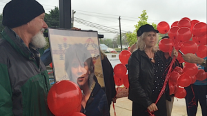 Pete Reimann, Sr. looks on as his wife, Doreen, pays tribute to their daughter's memory.  Jeannette Baker Reimann died on April 15, 2014. 