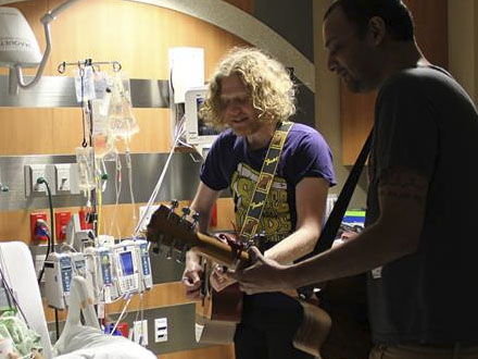 Songs for Kids founder Josh Rifkind (center) plays for patients at an even in 2013