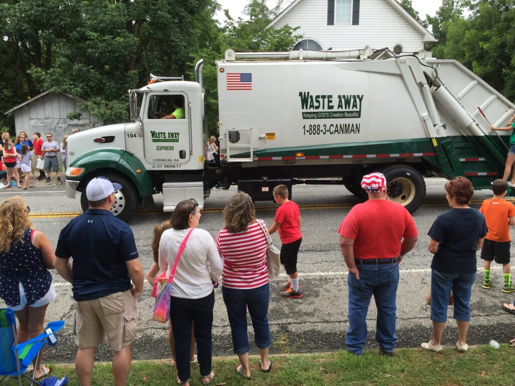 A squeaky clean garbage truck displayed its patriotism on parade.