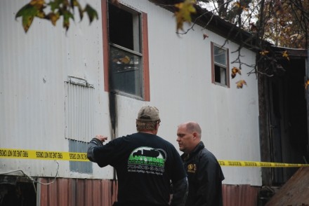 State Fire Investigator Brian Smith talks with Maintenance worker Robert Gaddis (back to the camera) on Tuesday during the fire investigation.