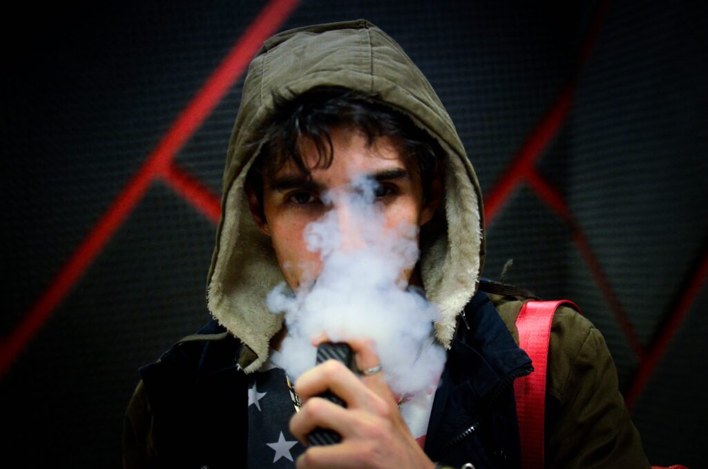 A young adult vaping.