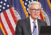 Federal Reserve cuts key rate, sees healthier economy next year